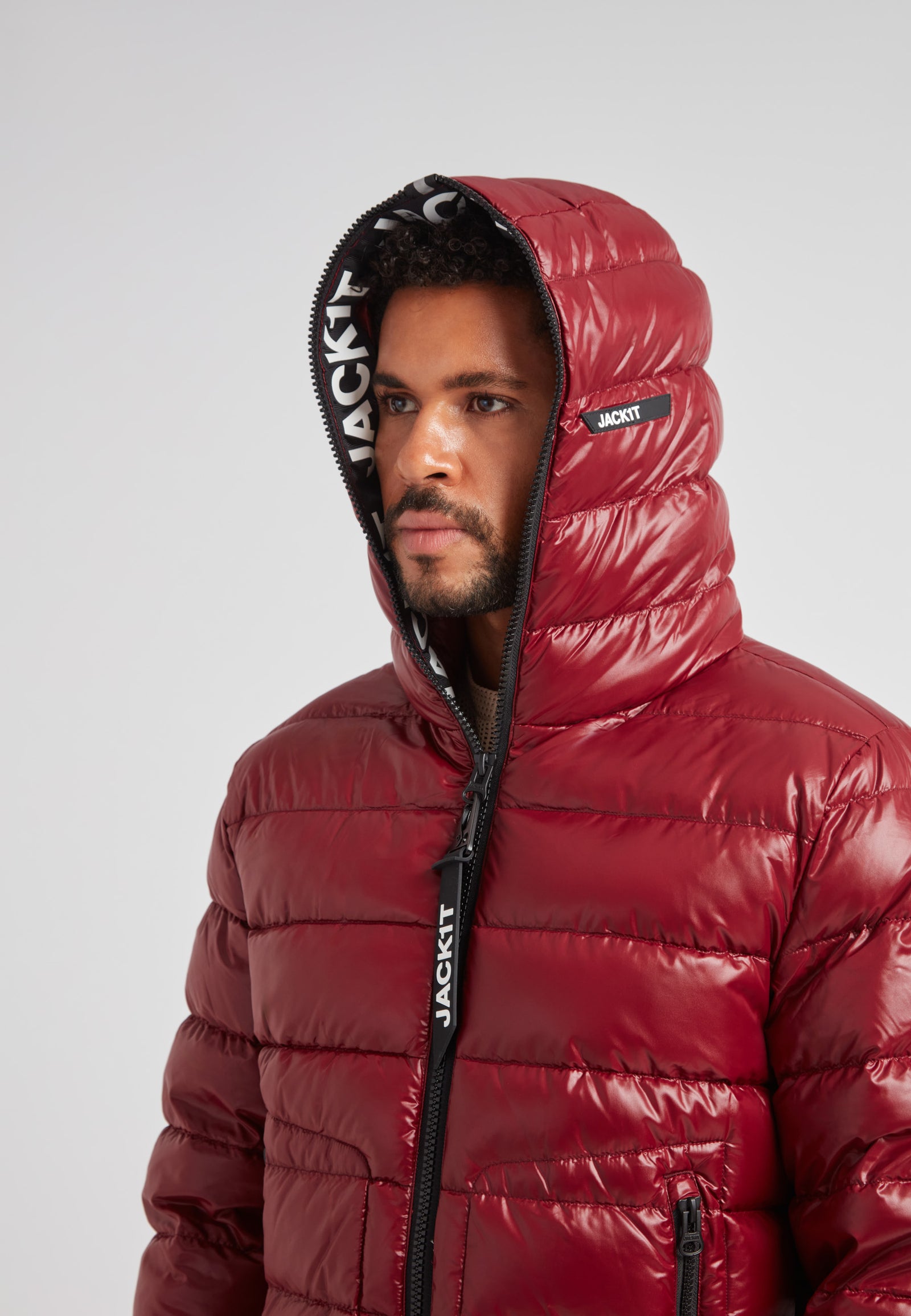R4D Tramline Puffer Racer Jacket Lux Red displayed on a model with the hood up, showcasing its sleek design.