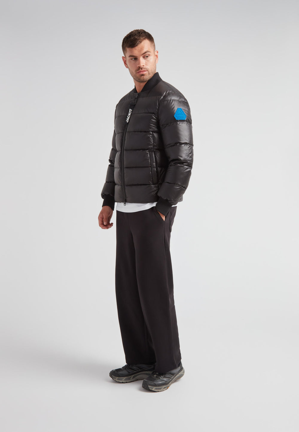 Man wearing a Vortex Black Bomber Jacket, featuring a modern design and durable material, stylish and functional.