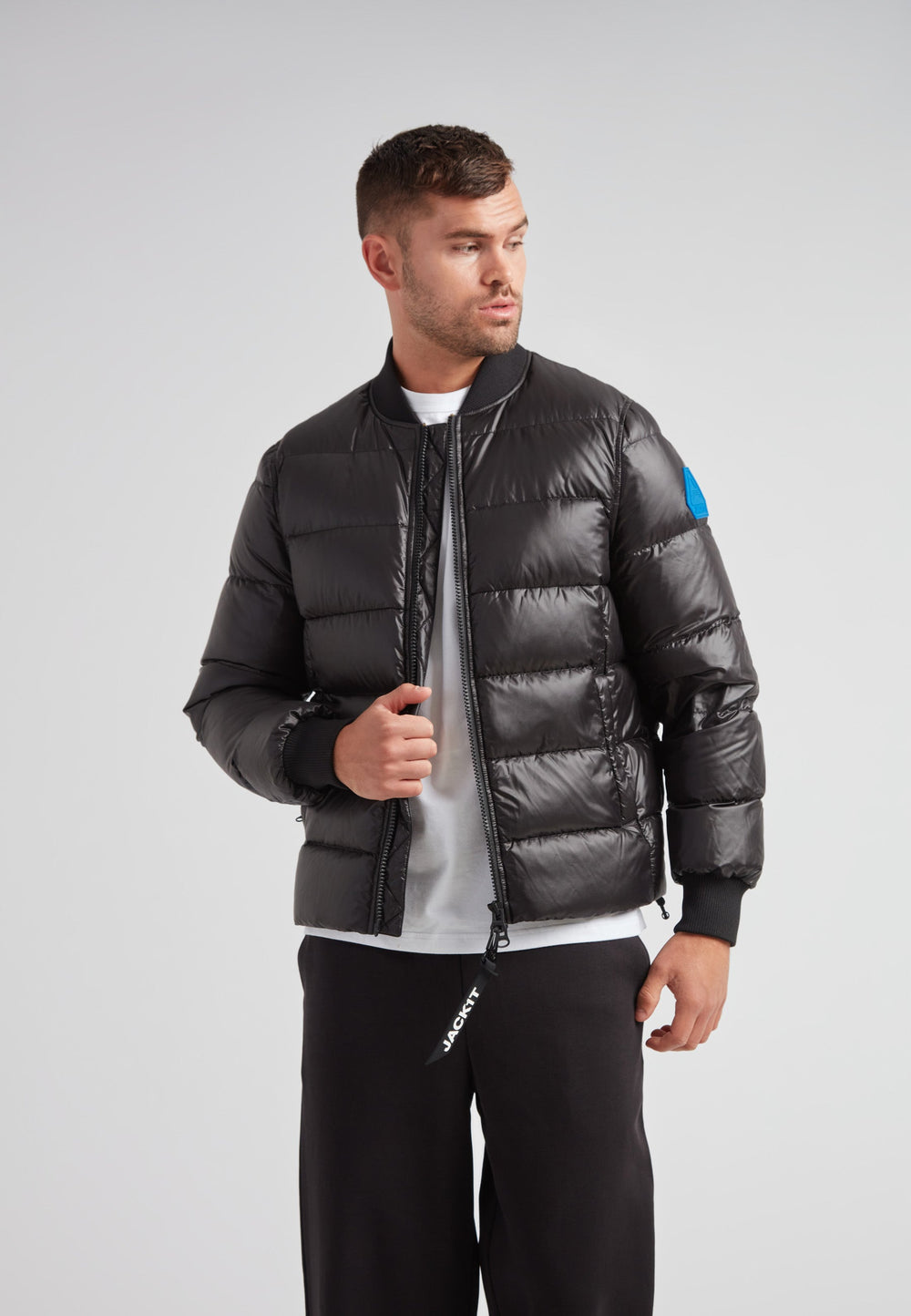 Man wearing a stylish Vortex Black Bomber Jacket with a modern design and durable water-repellent features.