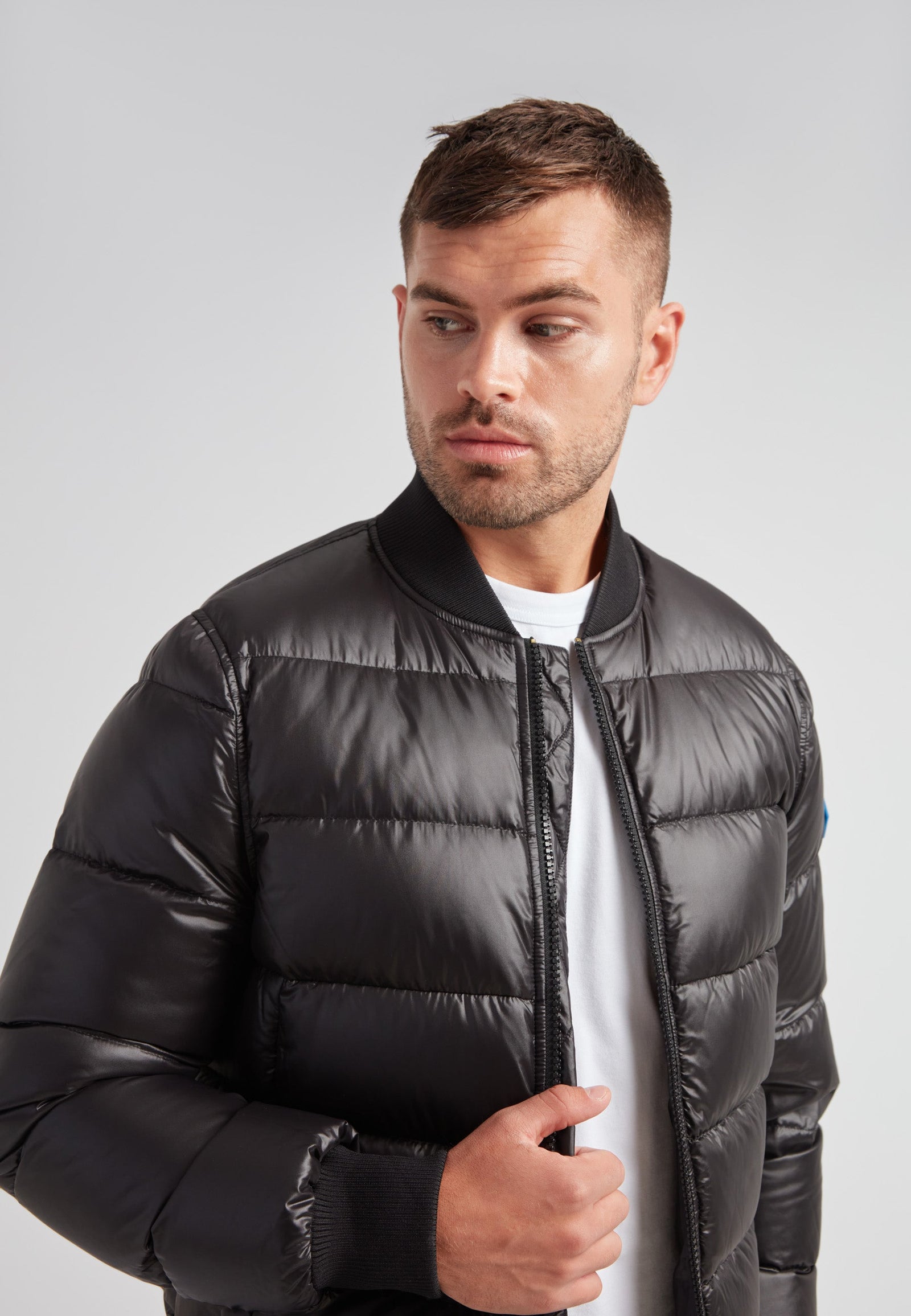Man wearing a Vortex Black Bomber Jacket, showcasing its stylish and modern design.