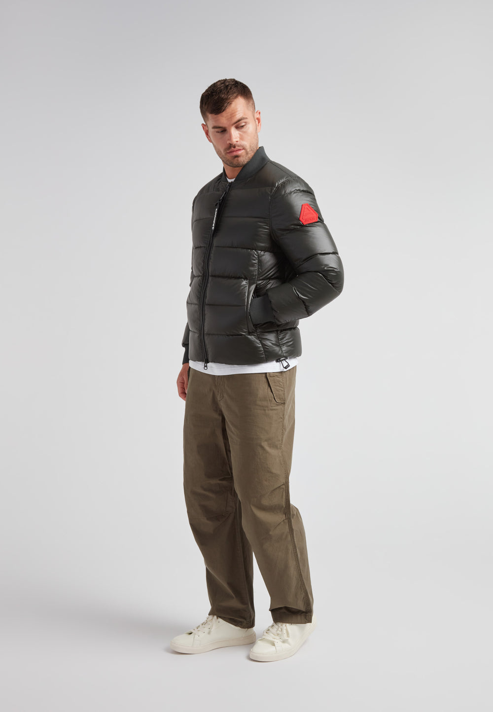 Vortex olive bomber jacket displayed on a model, showcasing its modern design and performance features.