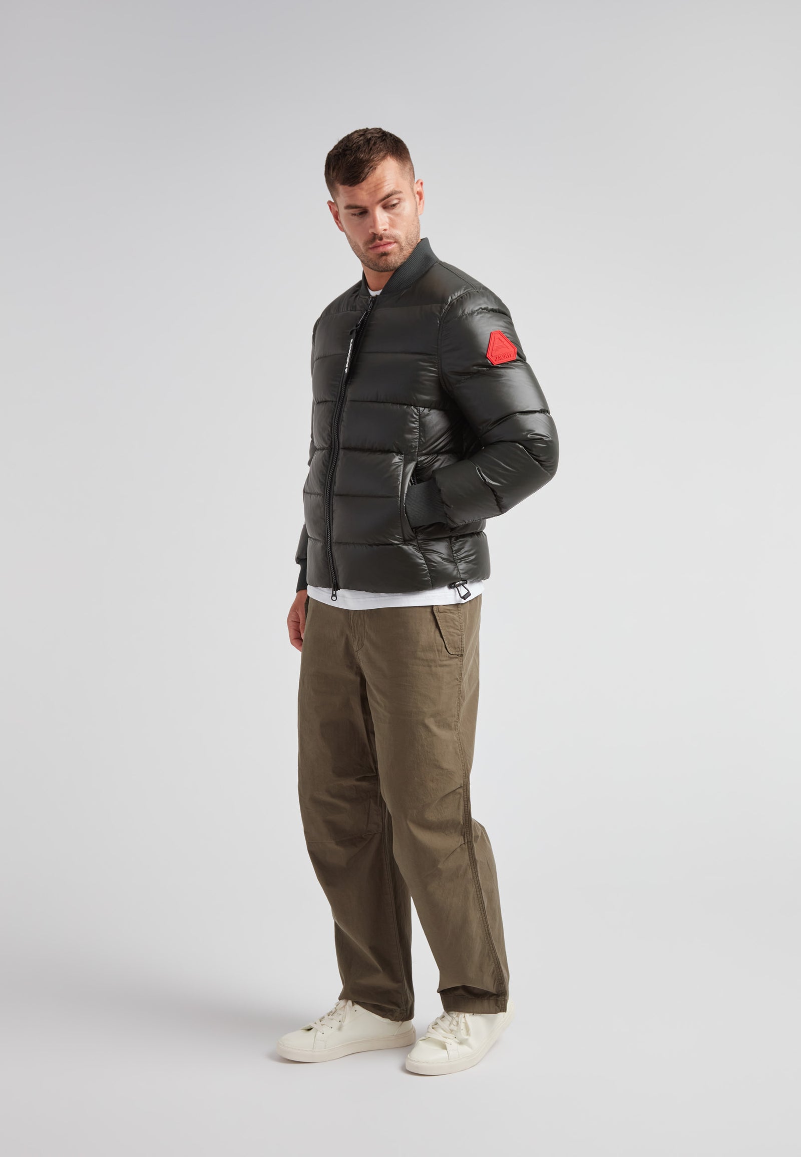 Vortex olive bomber jacket displayed on a model, showcasing its modern design and performance features.