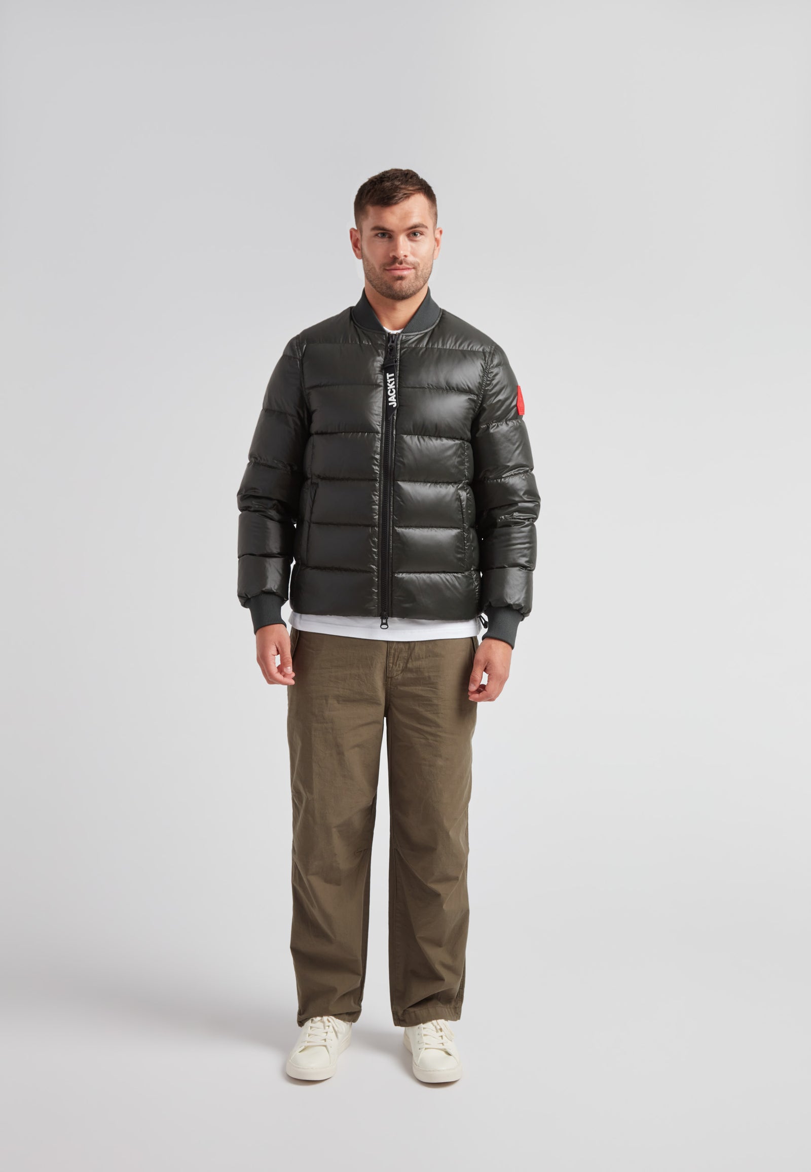 Man wearing a Vortex olive bomber jacket with a stylish design and durable material.