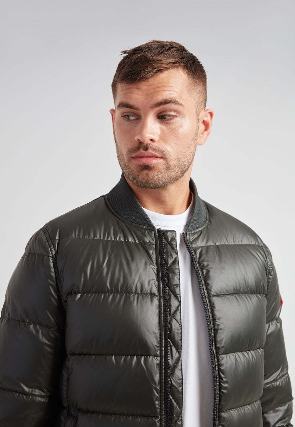 Vortex olive bomber jacket worn by a model showcasing its modern design and comfortable fit.