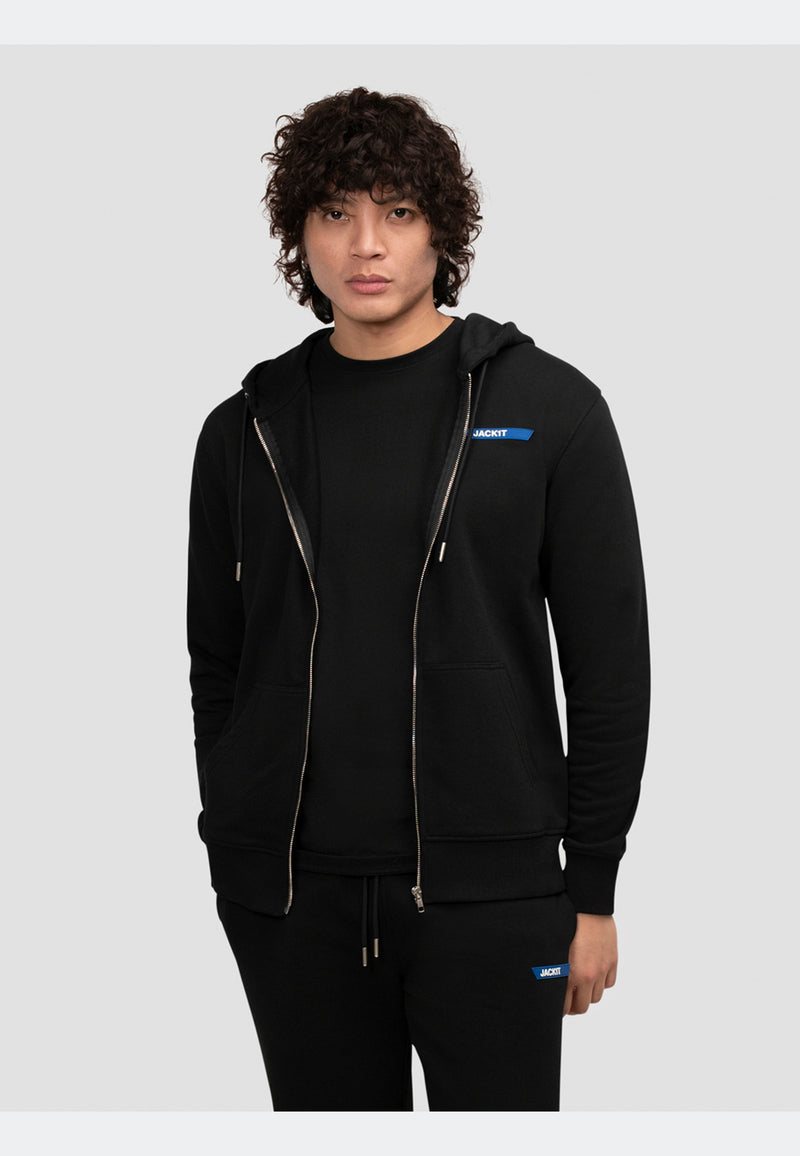 Model wearing a black hoodie zip through with refined brand detailing and a relaxed fit.