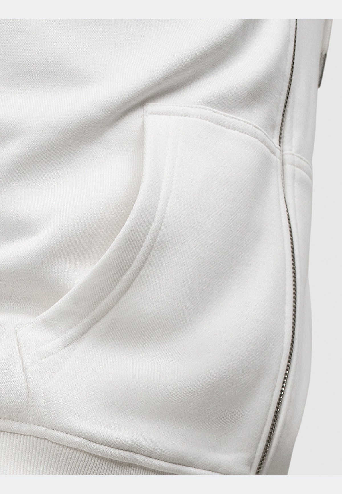 Detail of off white zip-through hoodie showcasing the pocket and fabric texture.