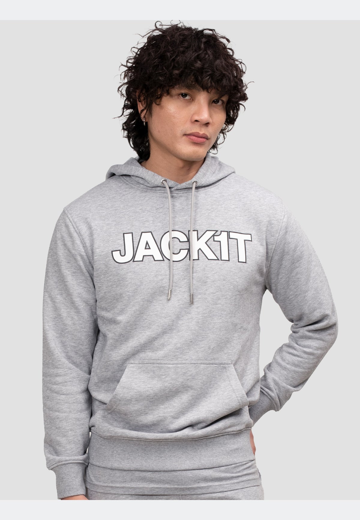 Model wearing a grey hoodie featuring a bold 'JACKIT' print, combining style and comfort.