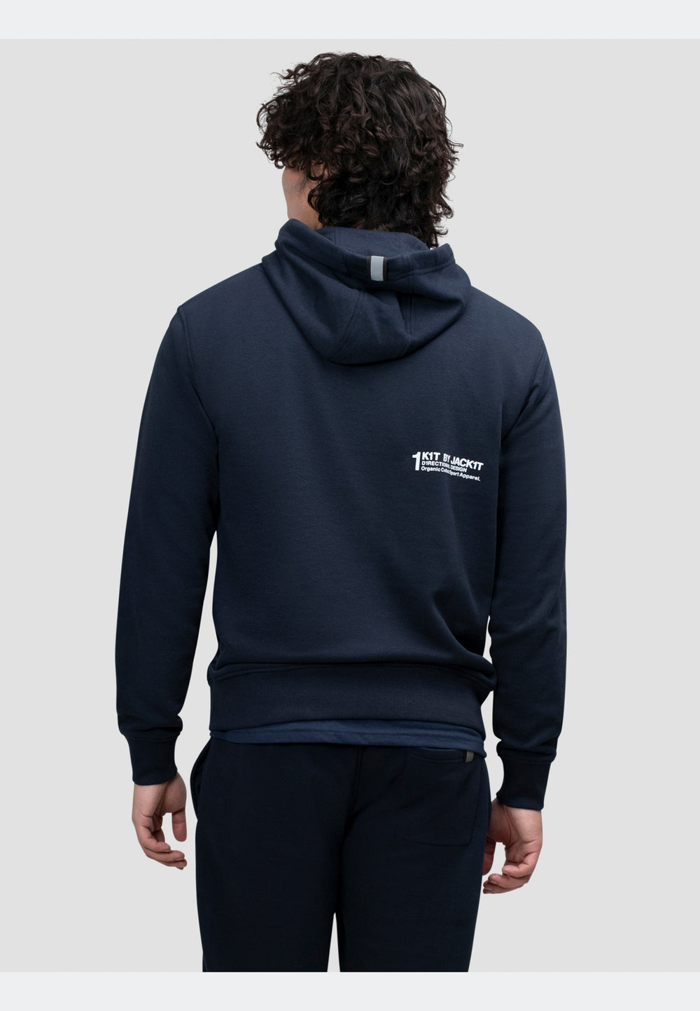 Back view of a person wearing a navy hoodie, showcasing its relaxed fit and hood detail.
