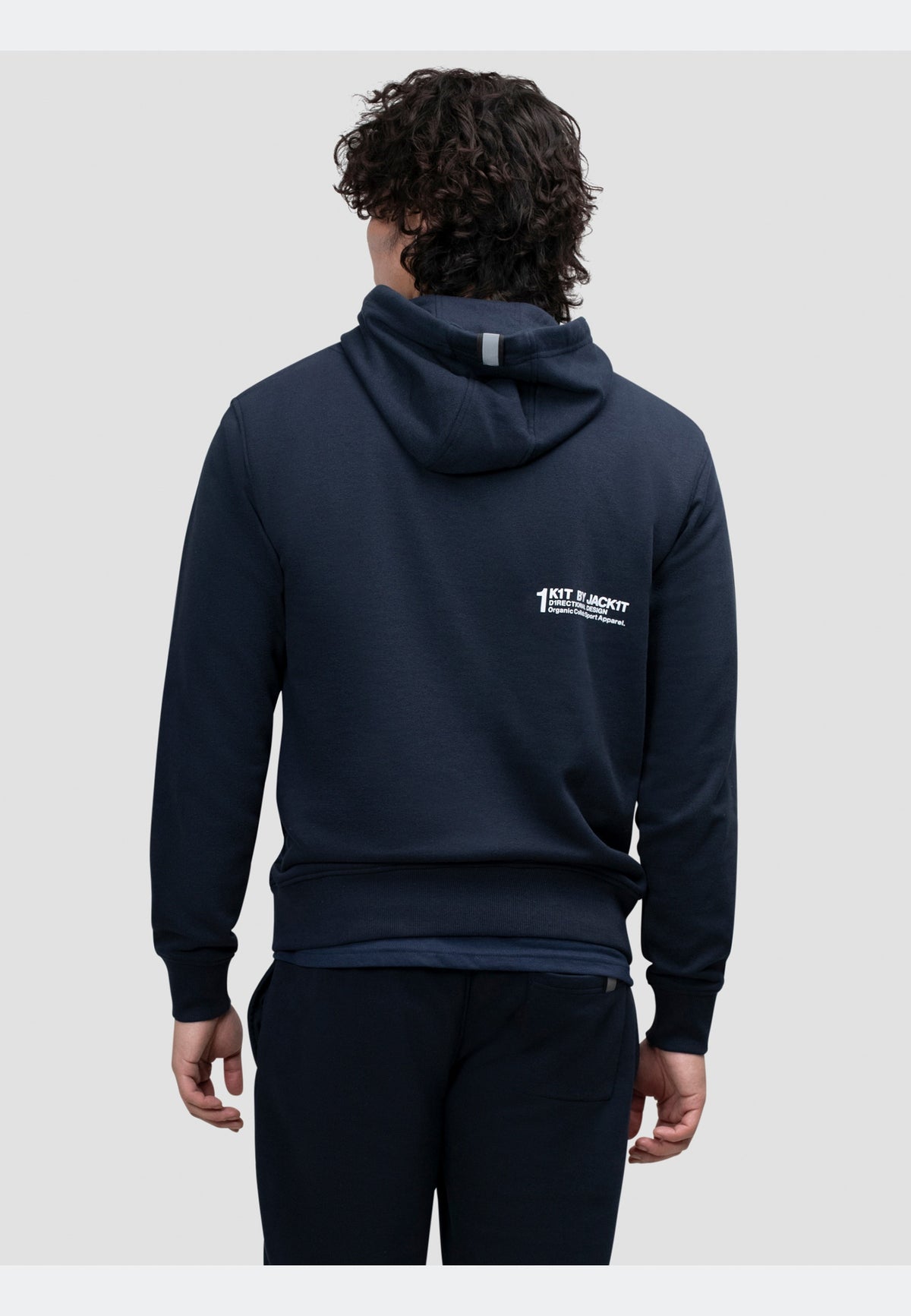 Back view of a person wearing a navy hoodie, showcasing its relaxed fit and hood detail.