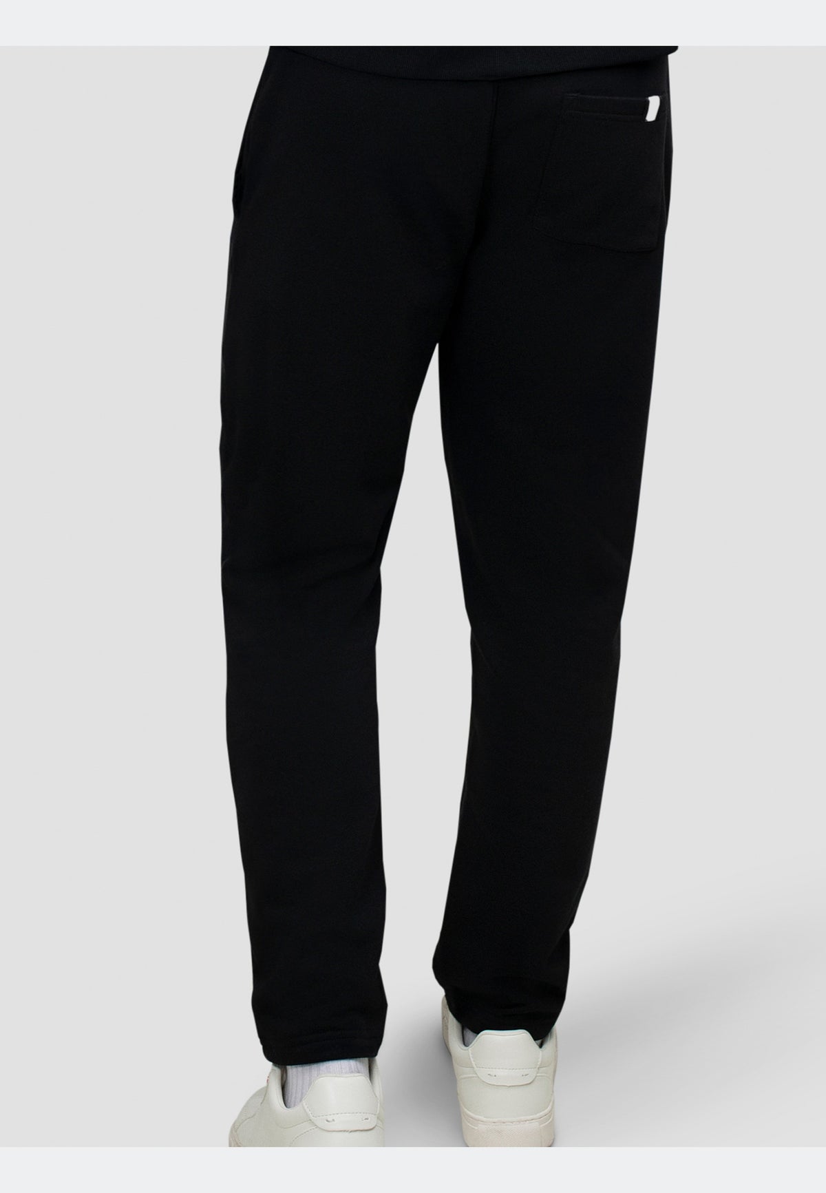 Back view of black joggers featuring a straight-leg silhouette and elasticated waistband.