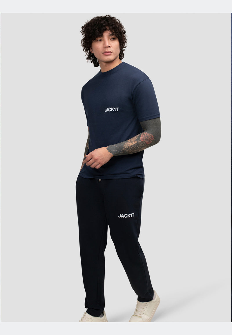 Model wearing navy joggers and matching navy t-shirt from JACKIT, showcasing a relaxed, stylish outfit.
