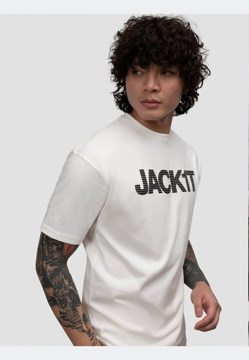 Model wearing an off white t-shirt with bold JACKIT graphic, showcasing a modern look.