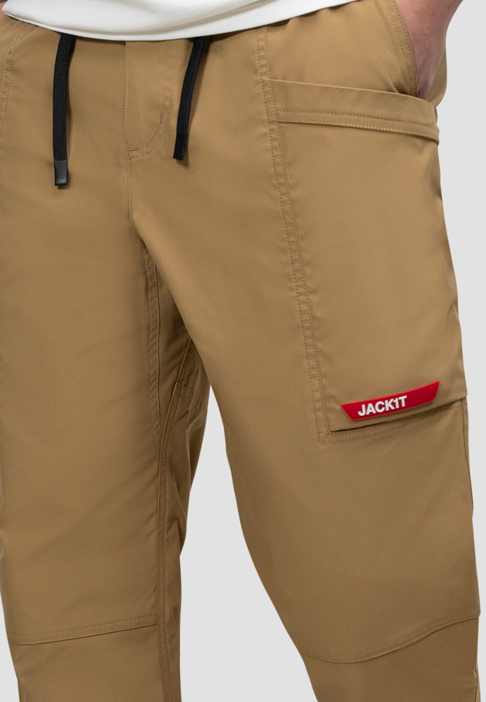 Men's sand cargo trousers with elastic waist and logo detail, perfect for casual wear and travel.