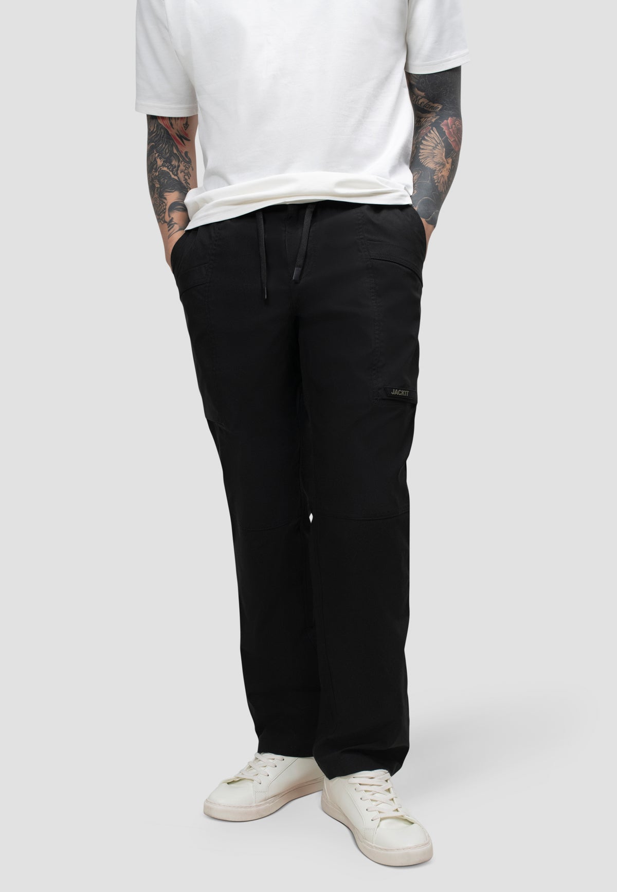 Model wearing men's black cargo trousers with elastic waist for comfort and relaxed fit.