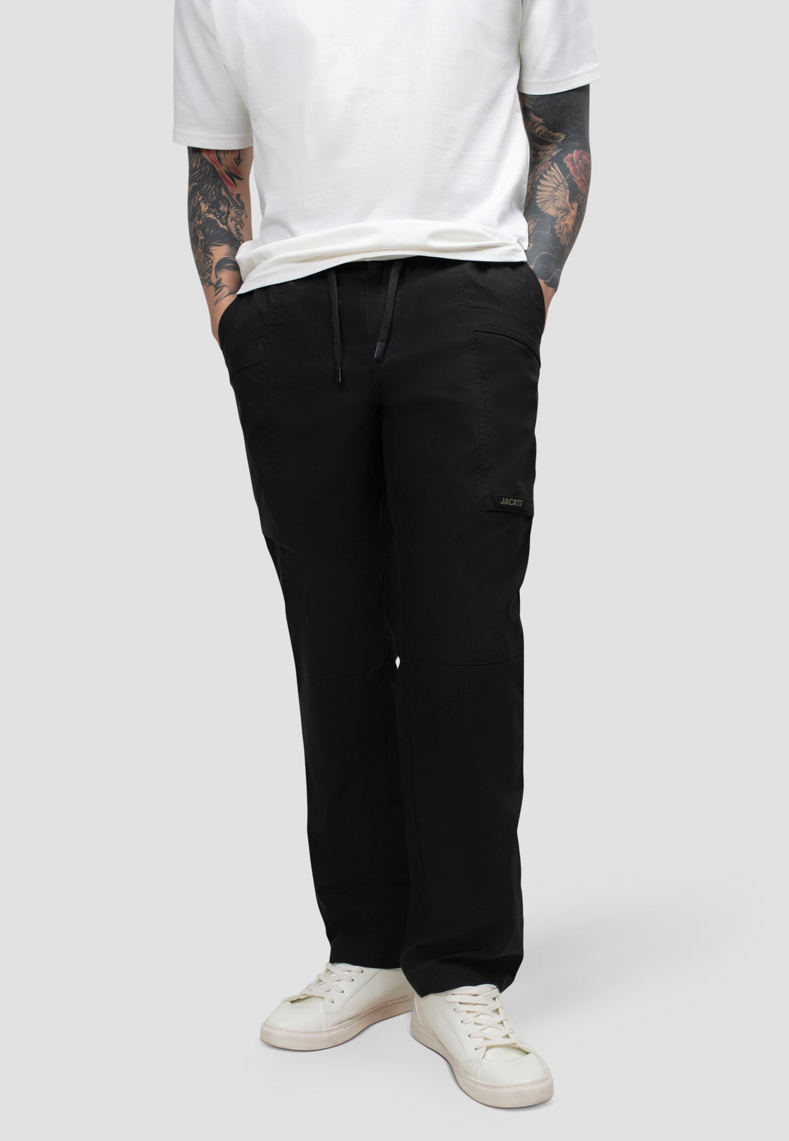 Model wearing men's black cargo trousers with elastic waist for comfort and relaxed fit.