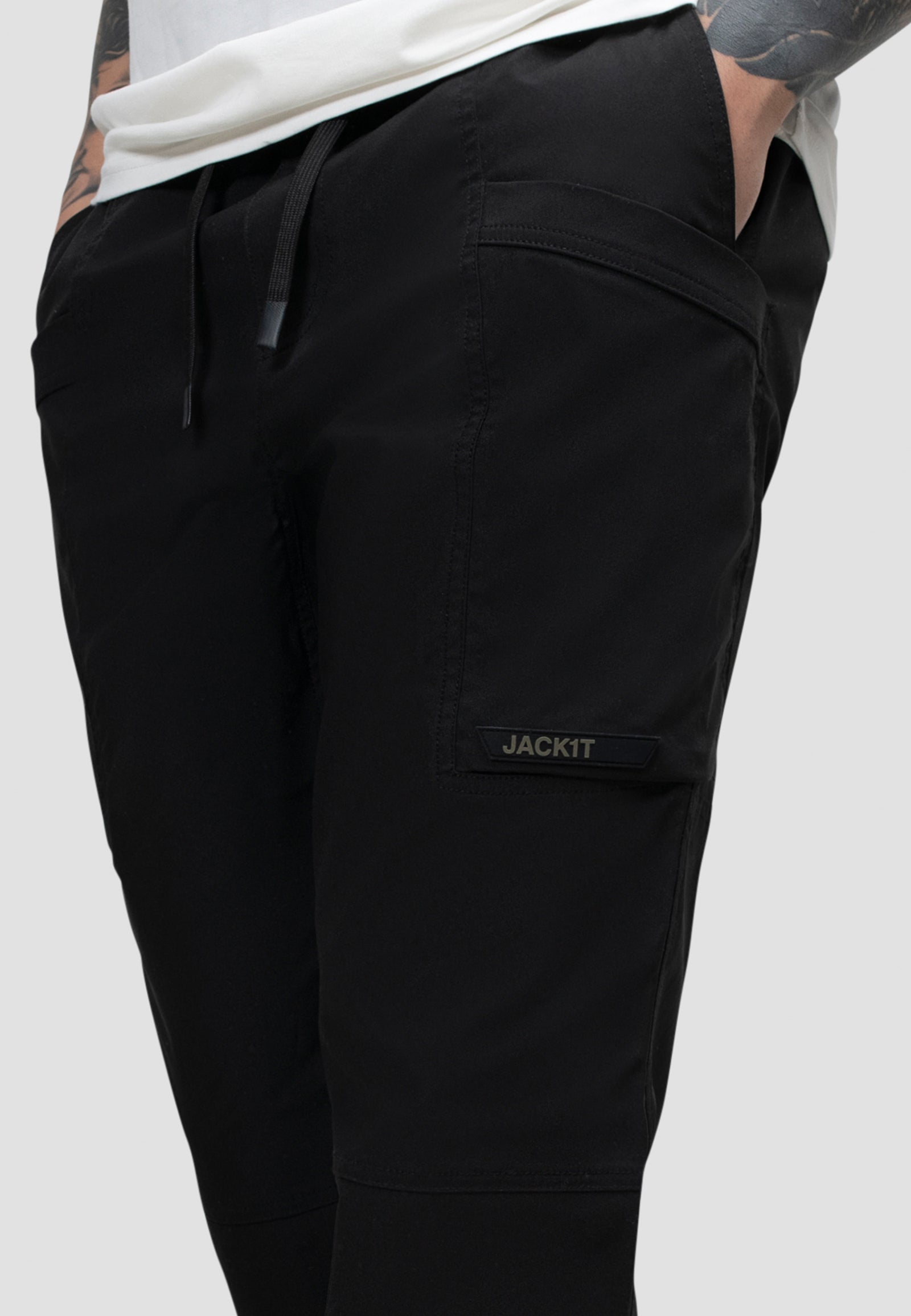 Men's black cargo trousers with elastic waist and relaxed fit, perfect for everyday wear and travel.