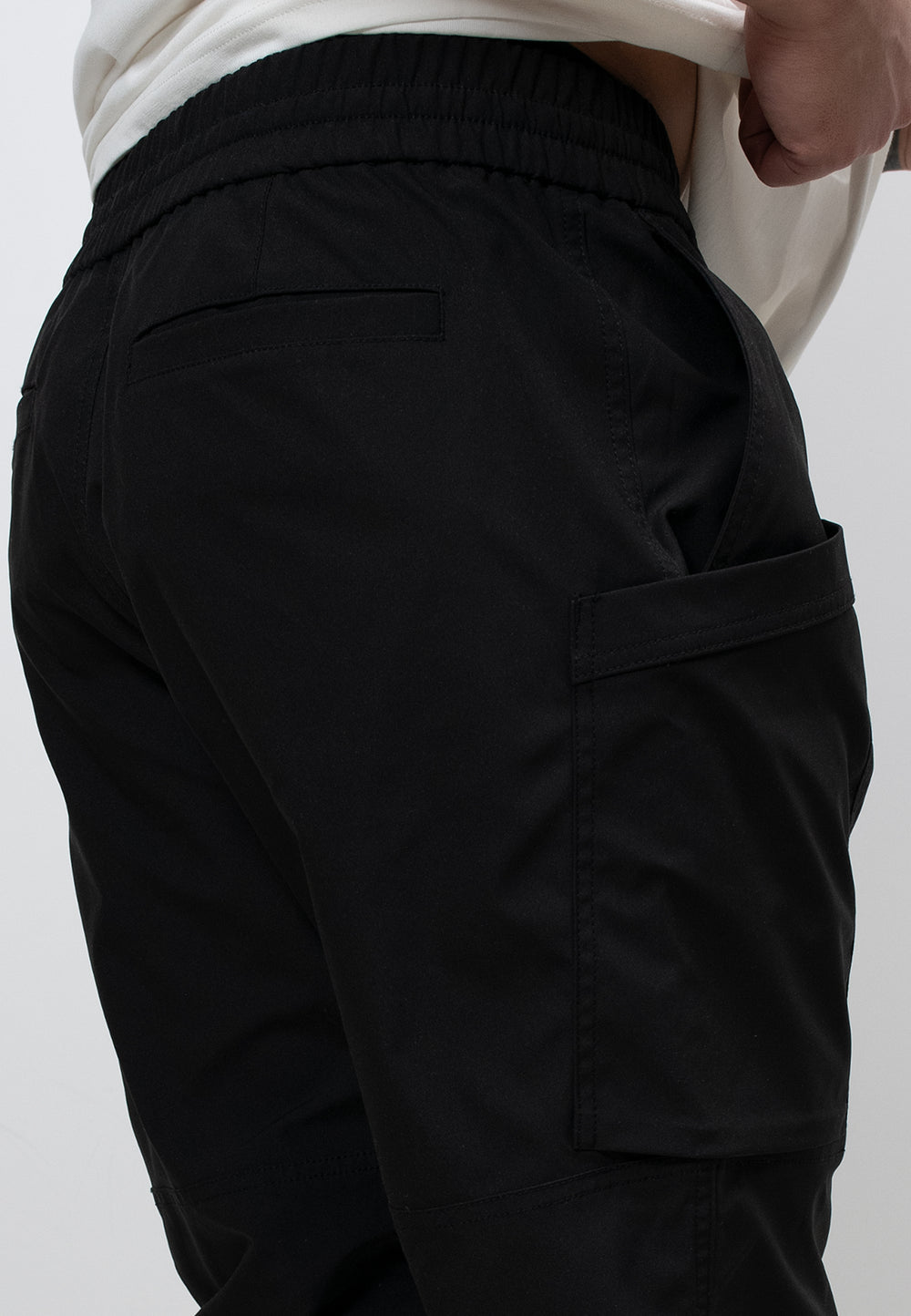 Mens Technical Black Cargo Trousers showing elasticated waist and side pockets for practical use.
