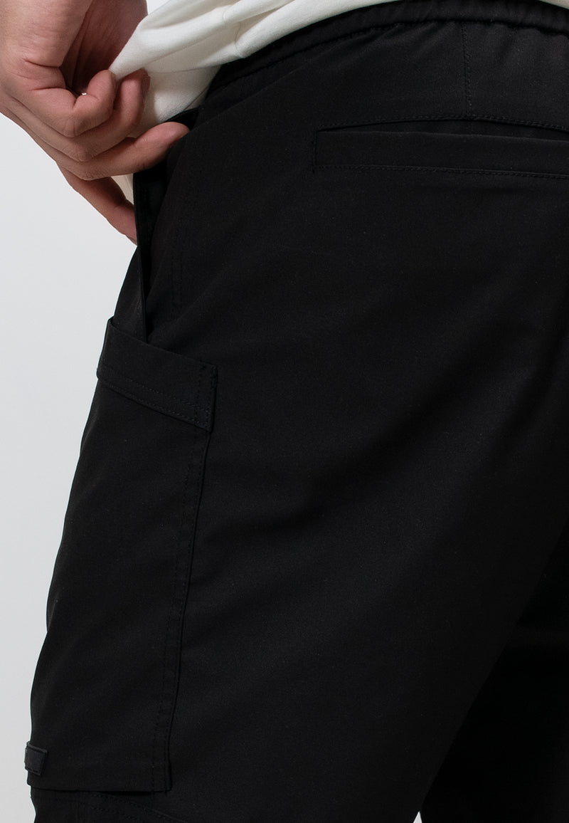 Close-up of lightweight men's black summer shorts with relaxed fit and elastic waist.