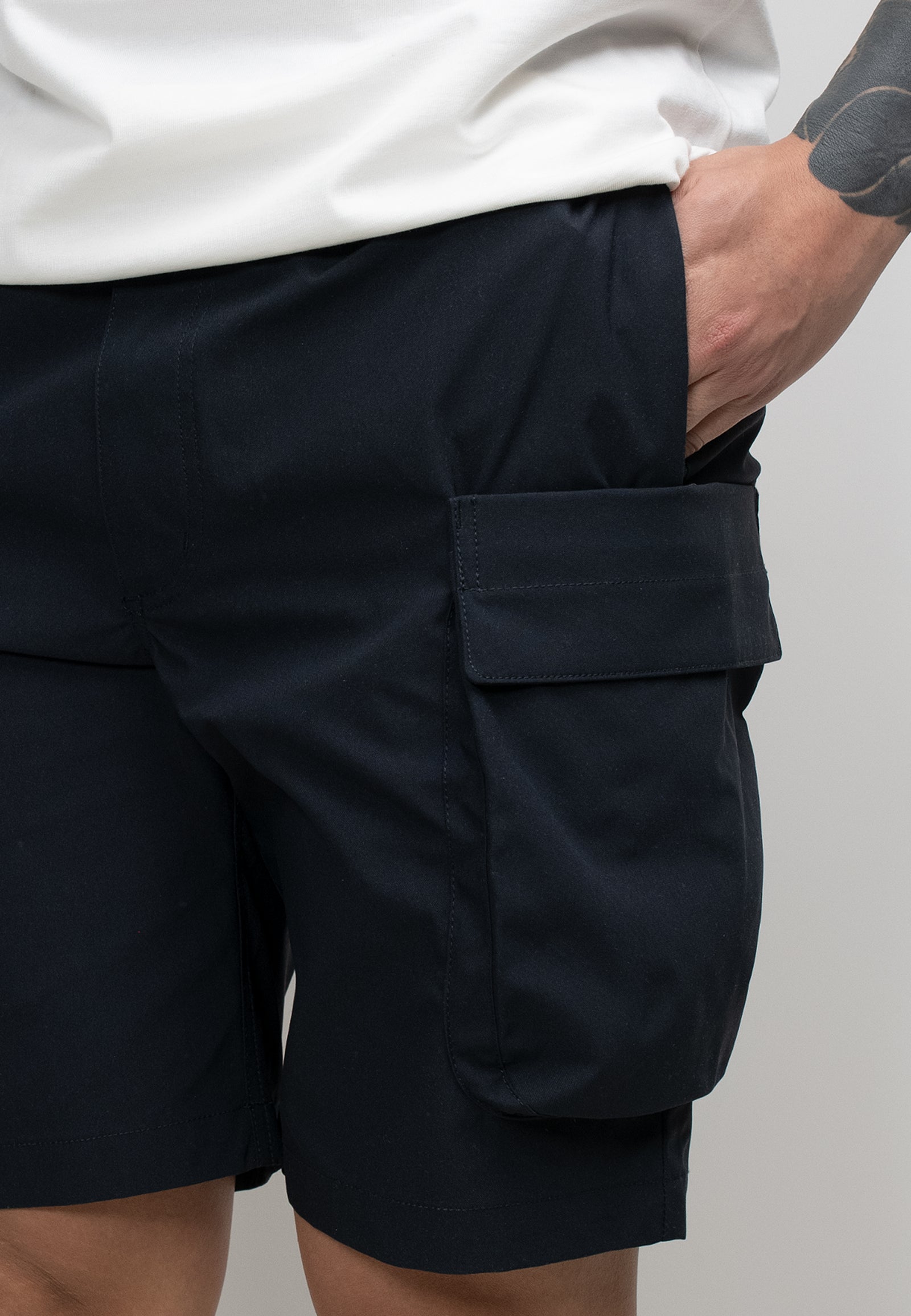 Men's navy cargo shorts showcasing utility pockets and a relaxed fit, perfect for summer activities.