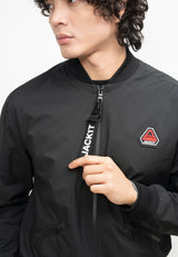 Model wearing Oberon Tech Bomber Jacket Black, showcasing the lightweight design and two-way zips, for mens black bomber jacket.