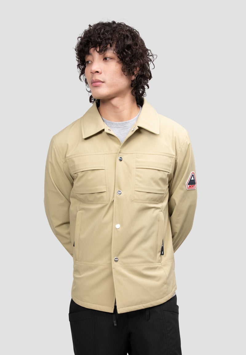 Mens Sand Shirt Jacket worn by a model with a curly hairstyle on a neutral background.