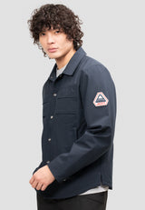 Model wearing Mens Navy Shirt Jacket, showcasing its lightweight, water resistant design and adjustable cuffs.