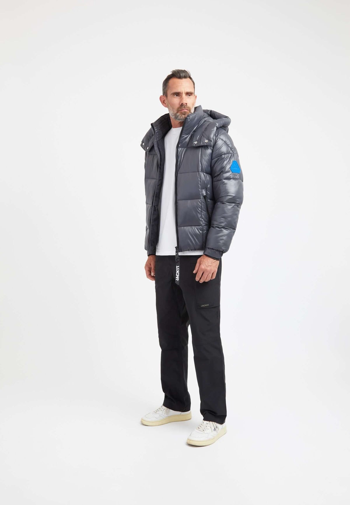 Model wearing Mens grey racer jacket, featuring tapered fit and premium insulation, styled with casual pants.