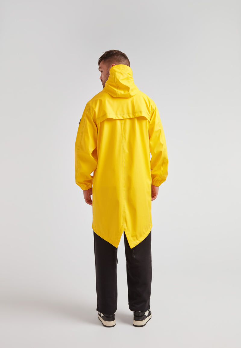 Back view of a model wearing a yellow unisex long raincoat, showcasing its lightweight design.