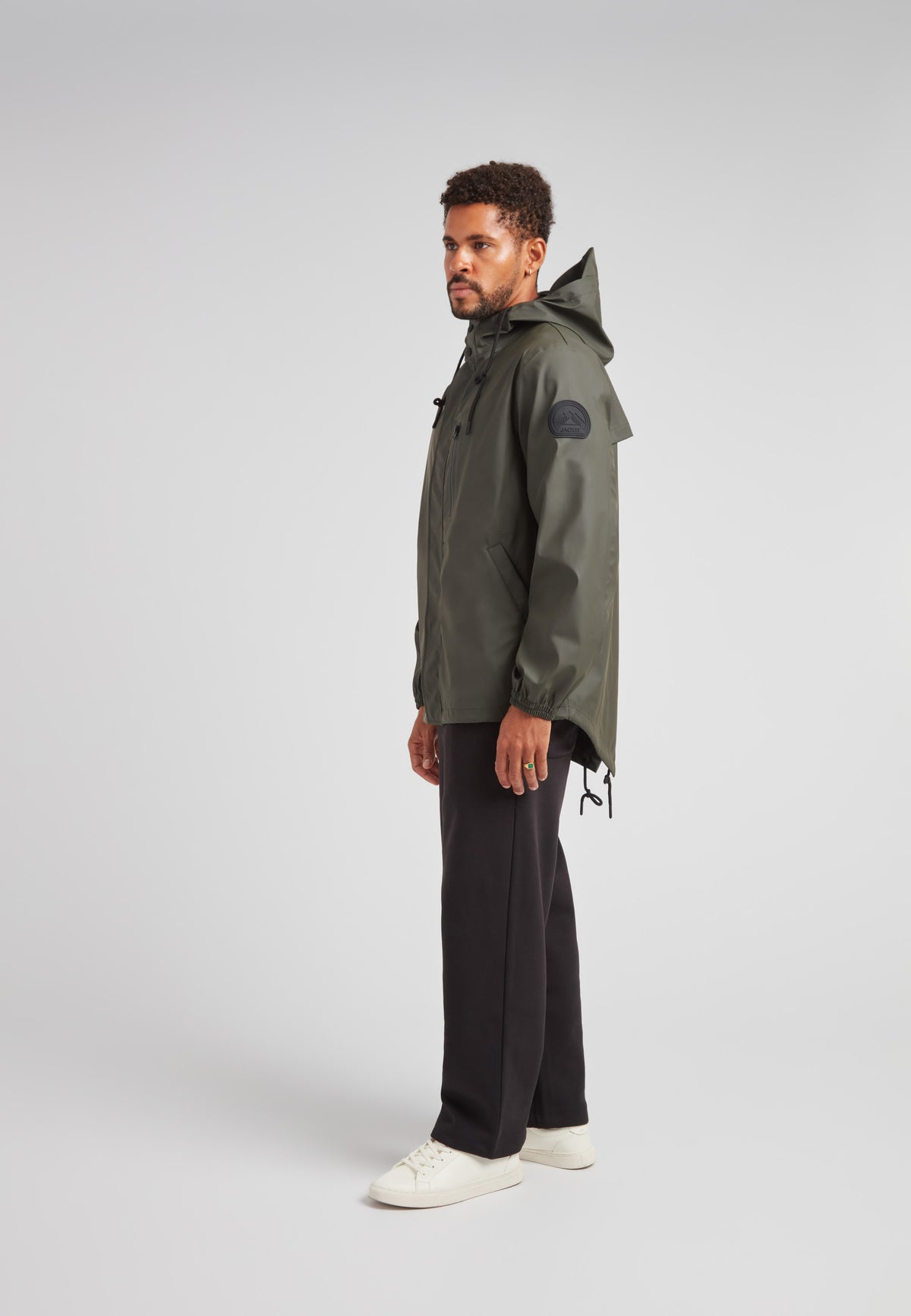 A man in stylish khaki ELEMENTS Unisex Raincoat 2.0 Khaki, showcasing versatility and weather protection.