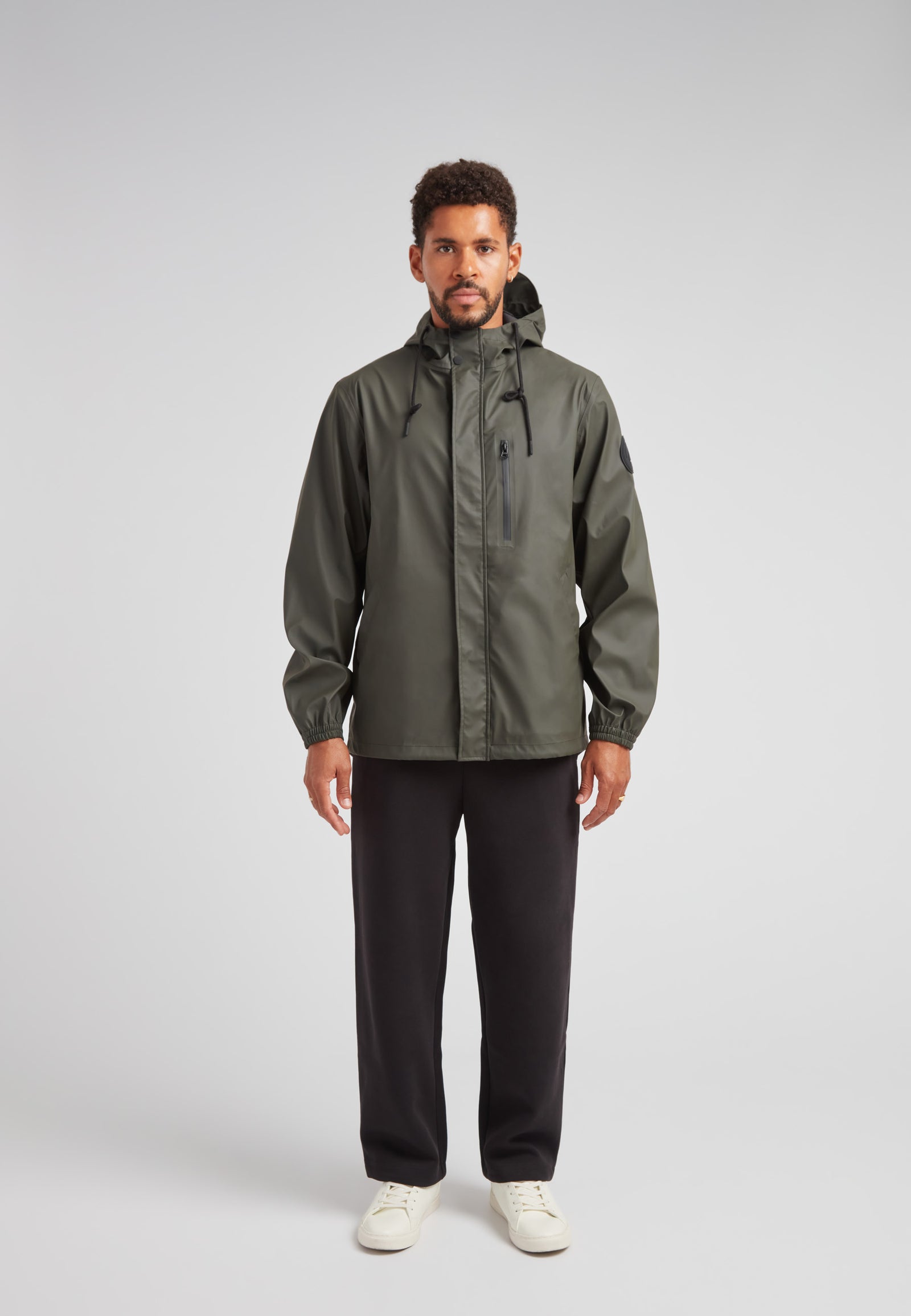 ELEMENTS Unisex Raincoat 2.0 Khaki worn by a model, showcasing lightweight weather protection in a stylish design.
