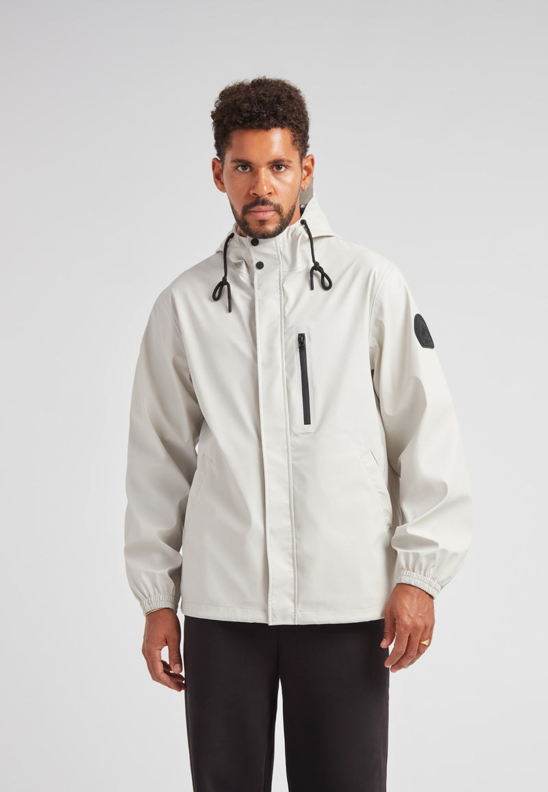 MODEL WEARING ELEMENTS Unisex Raincoat 2.0 Stone, showcasing a stylish and functional design in a neutral color.