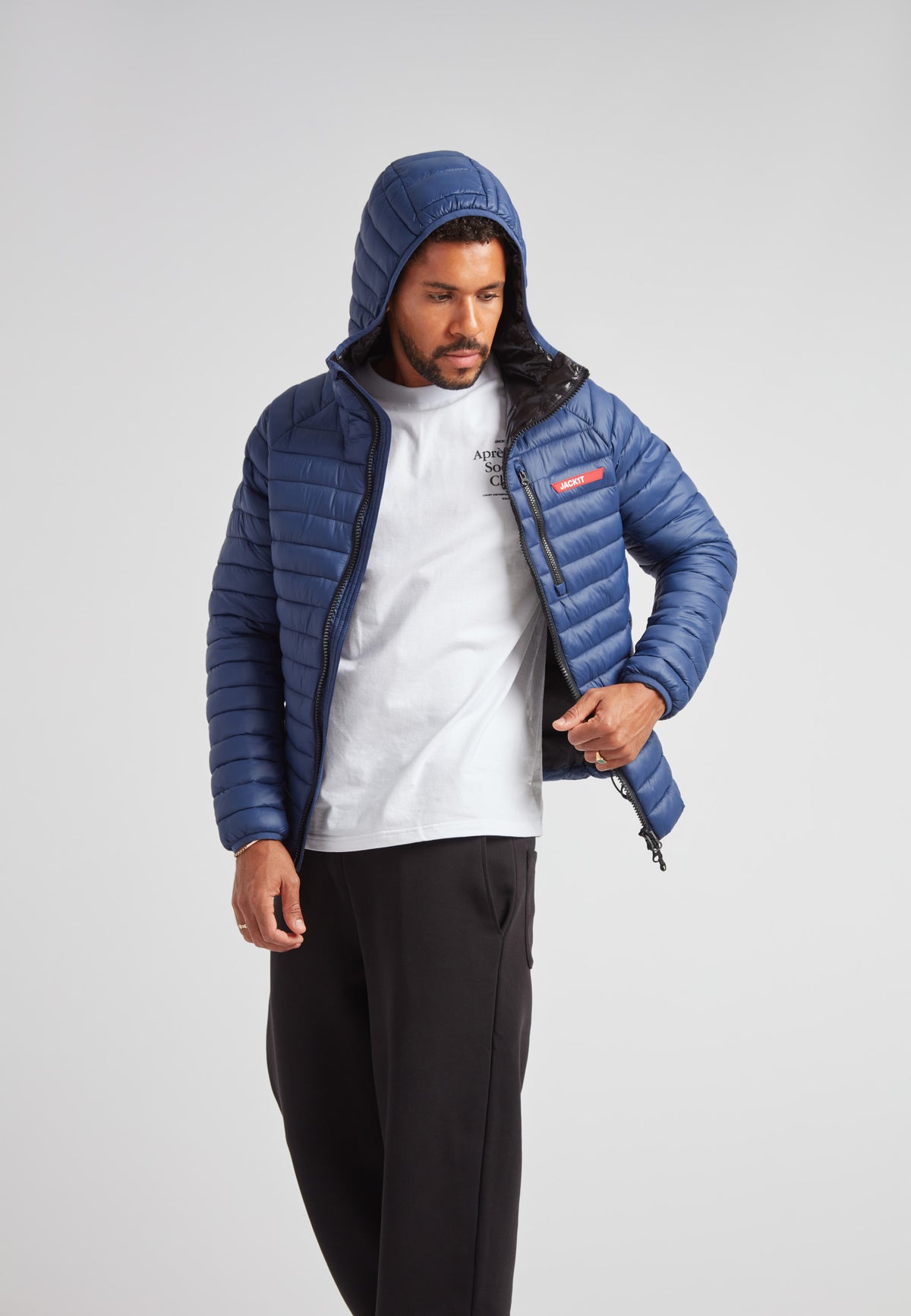 Man wearing SATEL1TE hooded jacket 2.0 pacific blue with hood up, casual outfit, mid-shine finish.