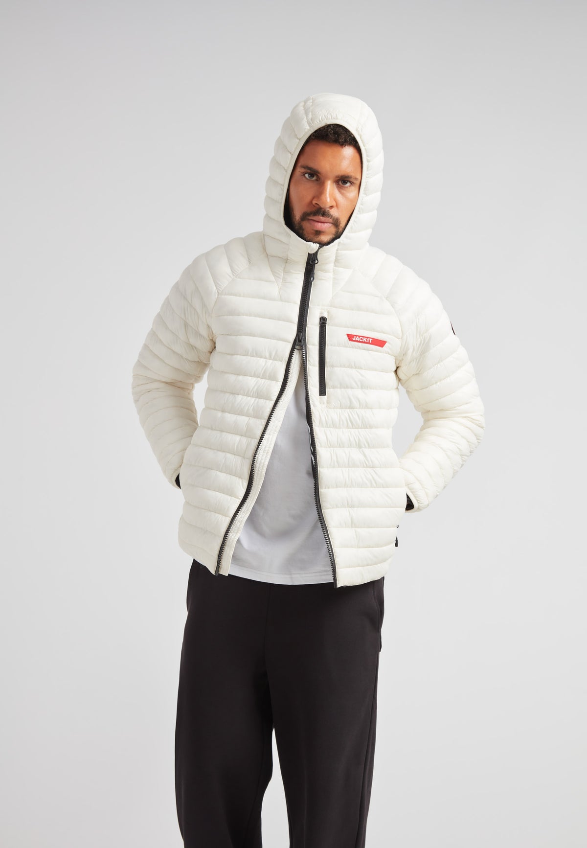 SATEL1TE Hooded Jacket 2.0 in cream color on model, showcasing modern design and performance features.