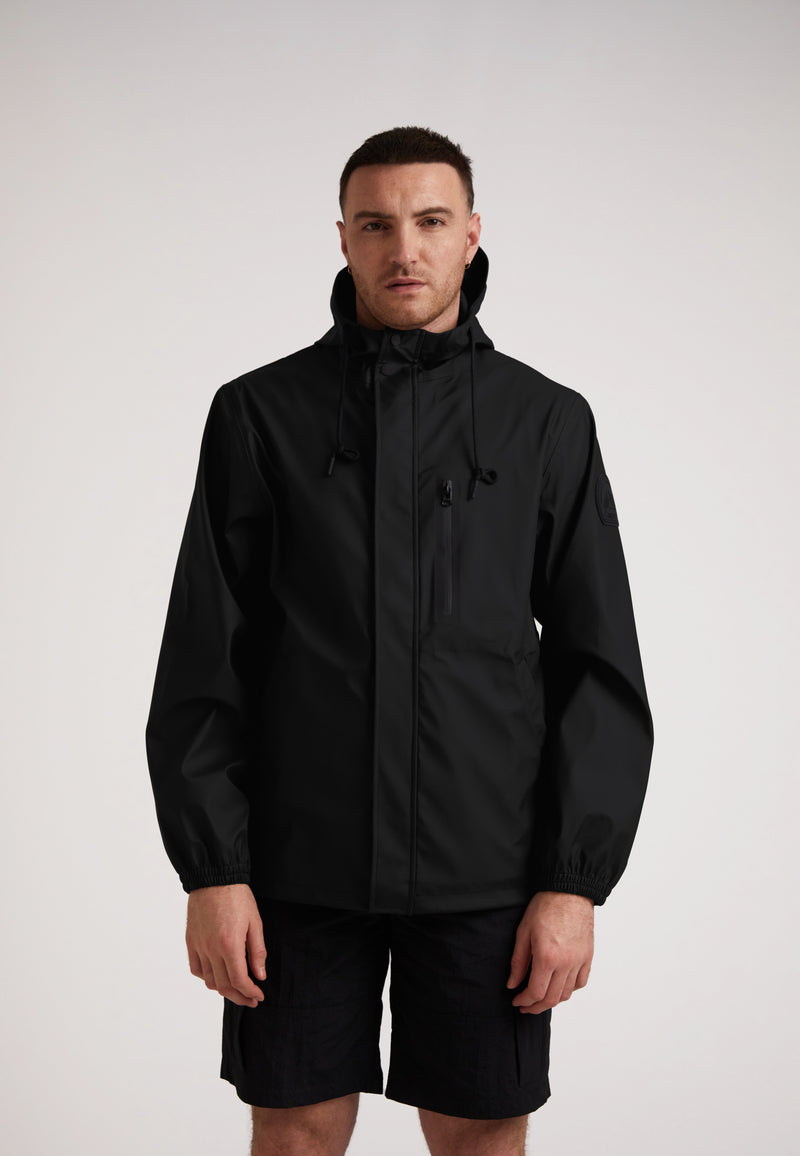 ELEMENTS Unisex Raincoat 2.0 Black modeled by a man, showcasing its lightweight weather protection and modern design.