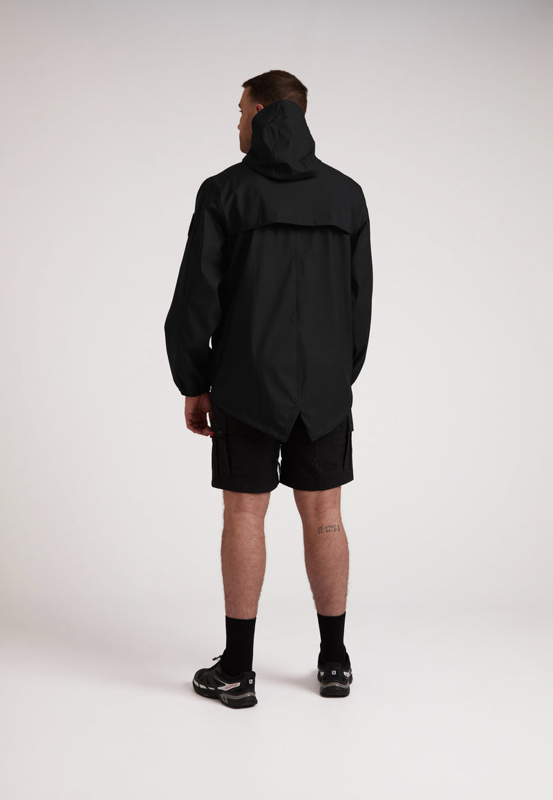 Back view of a model wearing the ELEMENTS Unisex Raincoat 2.0 Black with shorts, showcasing its lightweight design.