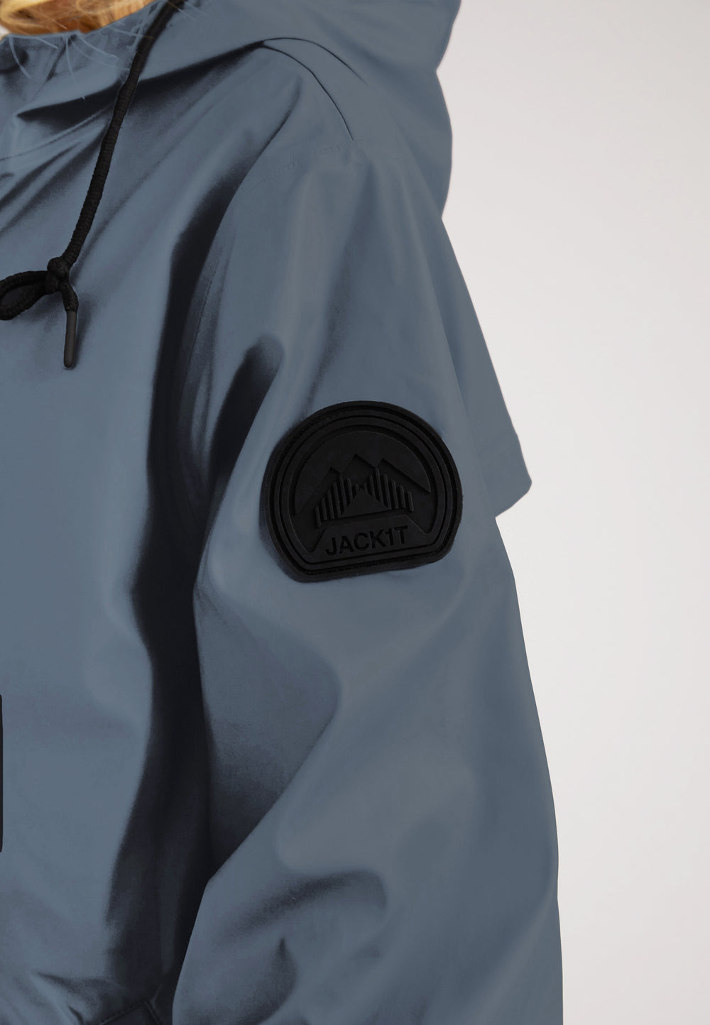 Close-up of the ELEMENTS Raincoat 2.0 Grey showcasing the logo and patch detail on the sleeve.