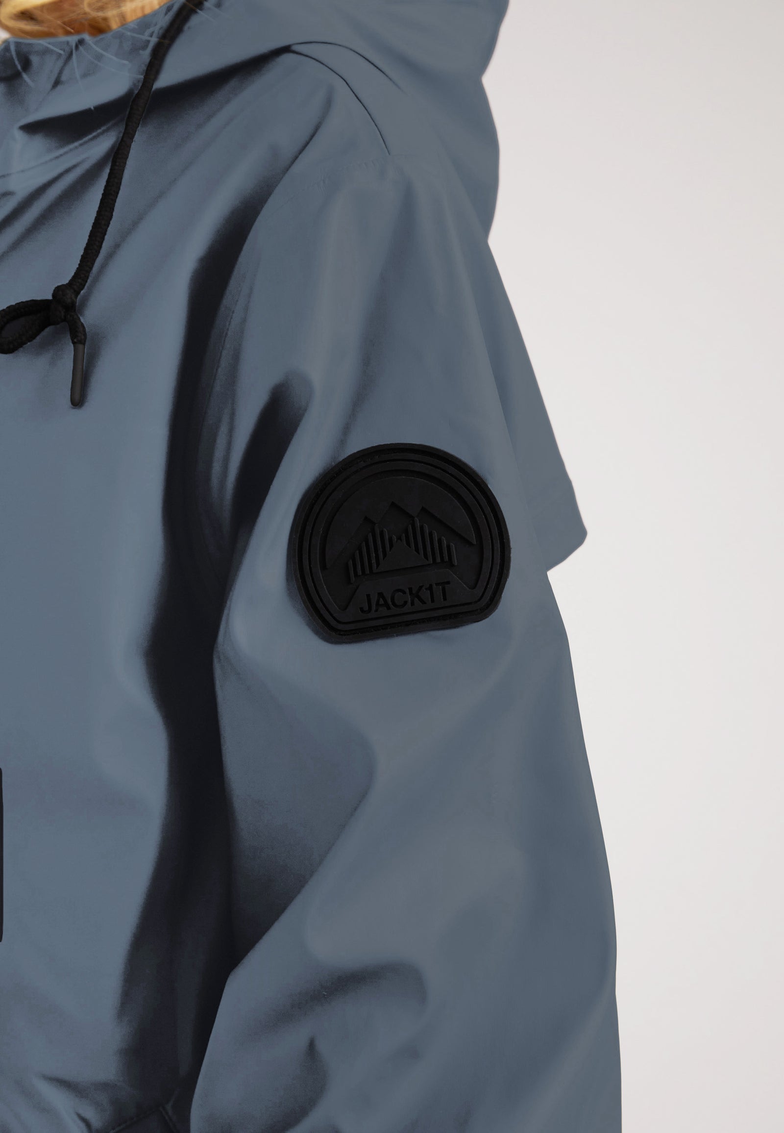 Close-up of the ELEMENTS Raincoat 2.0 Grey showcasing the logo and patch detail on the sleeve.