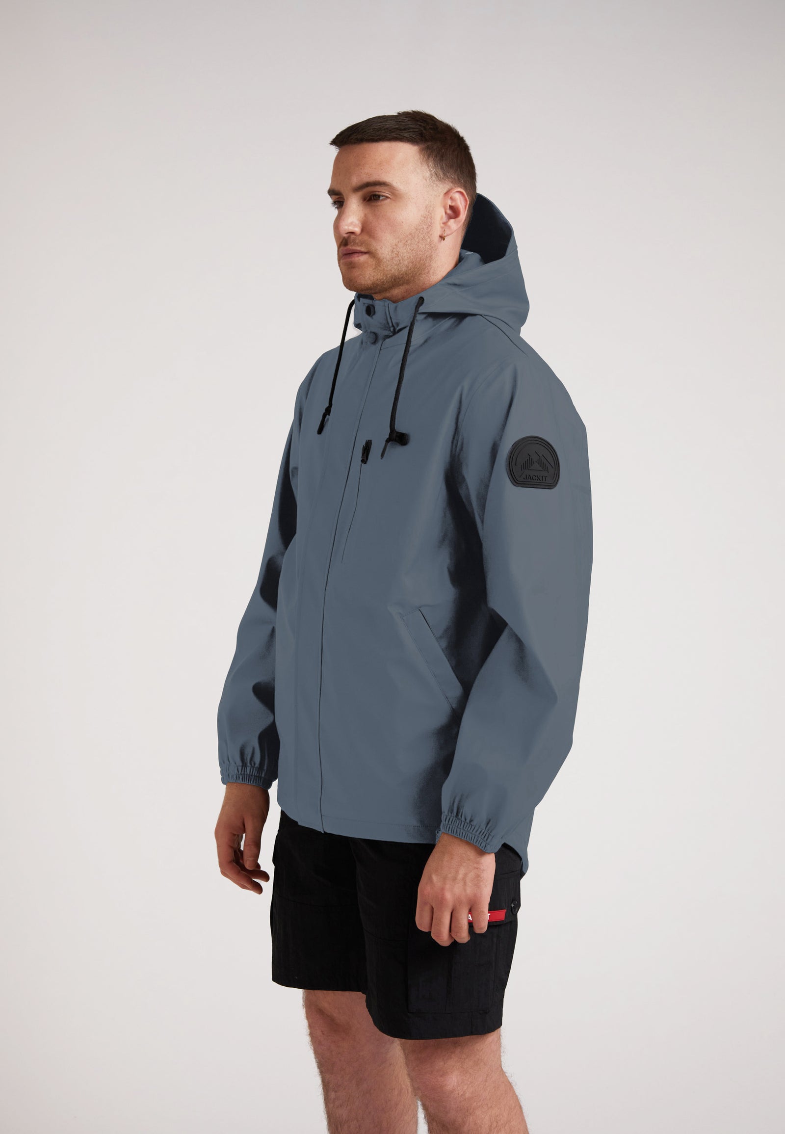 MODEL WEARING ELEMENTS Unisex Raincoat 2.0 Grey, showcasing lightweight weather protection and versatile design.