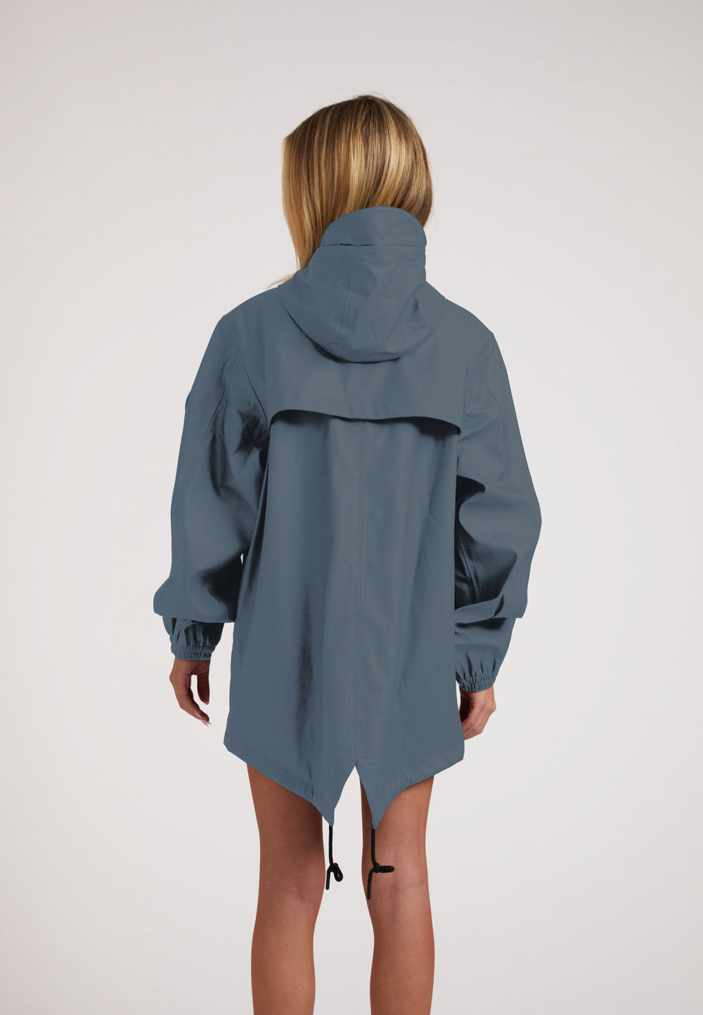 Woman wearing ELEMENTS Raincoat 2.0 Grey from the back, showcasing its lightweight design and comfortable fit.