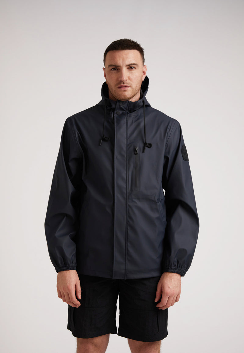 ELEMENTS Unisex Raincoat 2.0 Navy on model, featuring a lightweight waterproof design for all seasons.