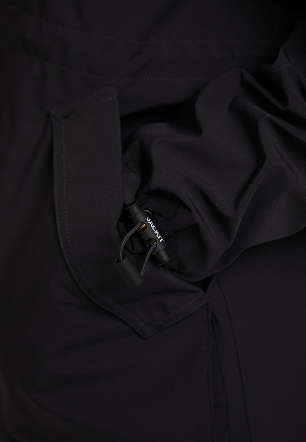 Close-up of the HELIO Mid Windbreaker Black showcasing its lightweight fabric and adjustable features.