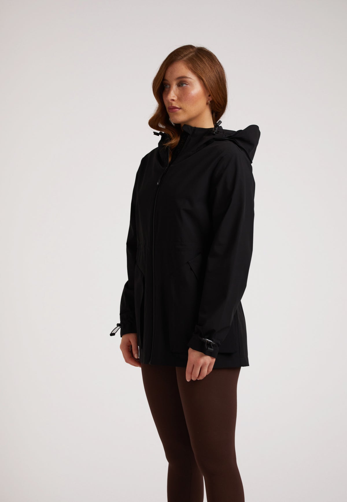 Model wearing HELIO Mid Windbreaker Black showcasing its lightweight design and windproof features.
