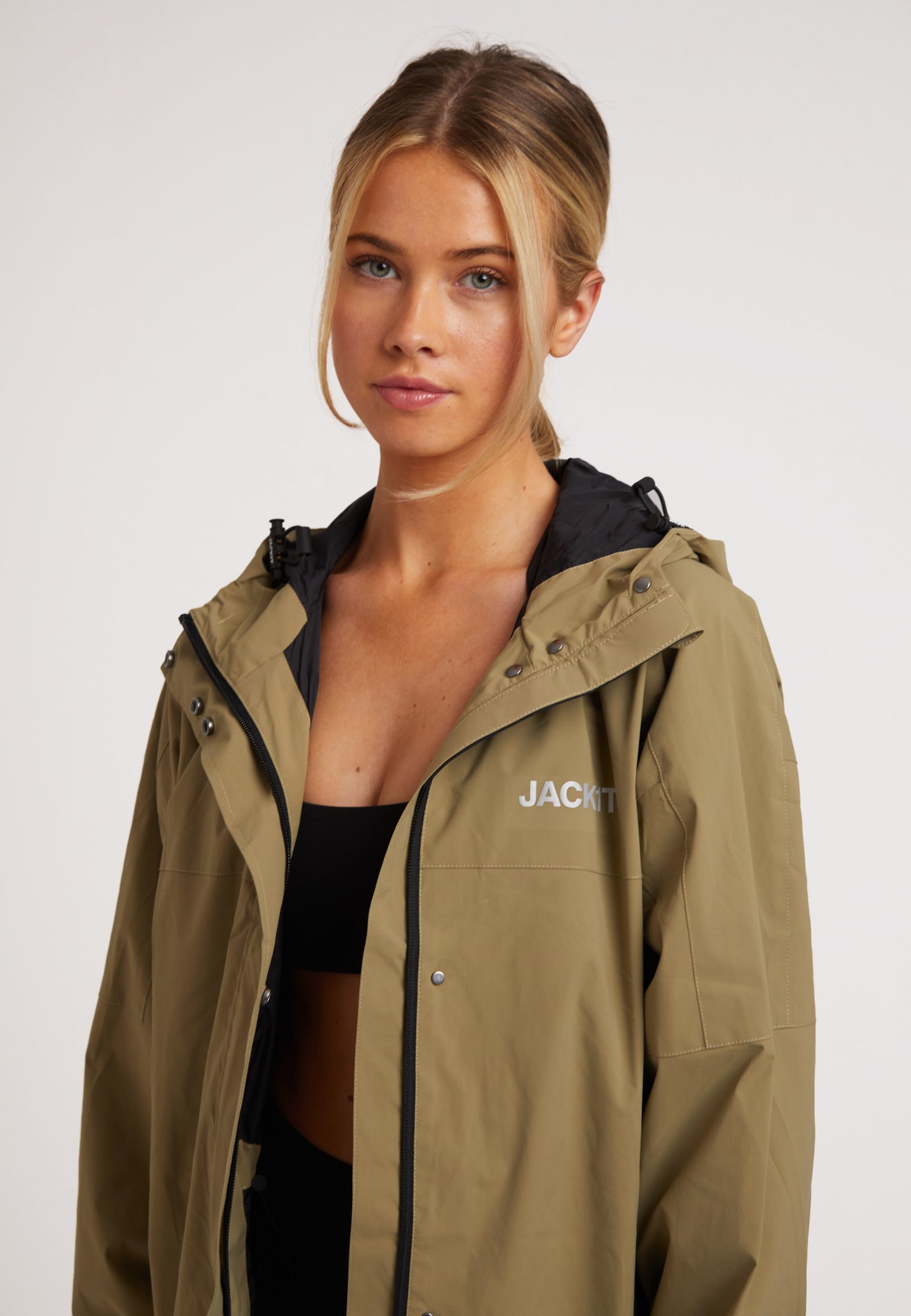 Model wearing ISOTOPE lightweight windbreaker, showcasing Ladies lightweight olive windbreaker design and features.