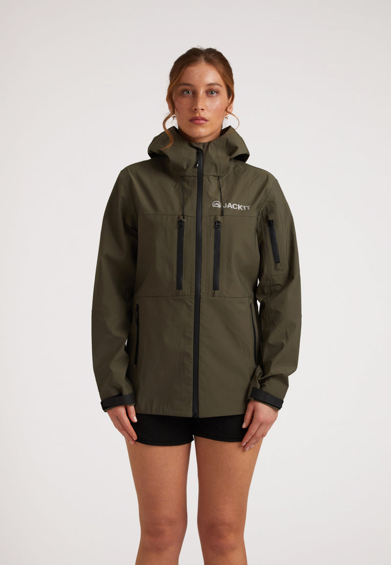 Waterproof ladies jacket in olive worn by model, showcasing stylish design and weather-resistant features.