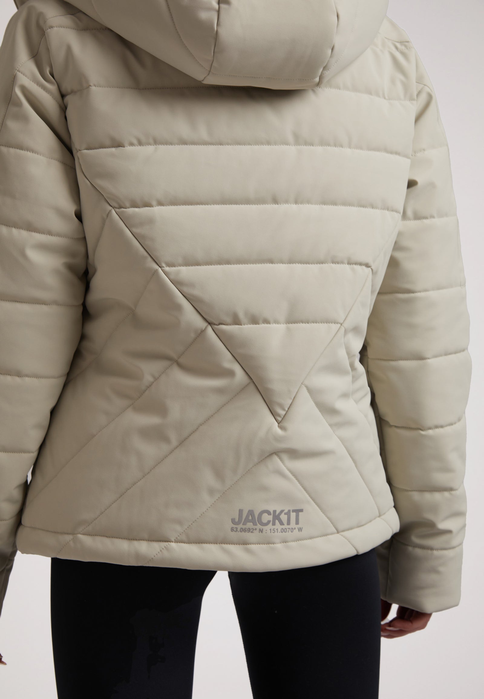 Back view of a LADIES PADDED LIGHTWEIGHT STONE JACKET featuring a hood and quilted design.