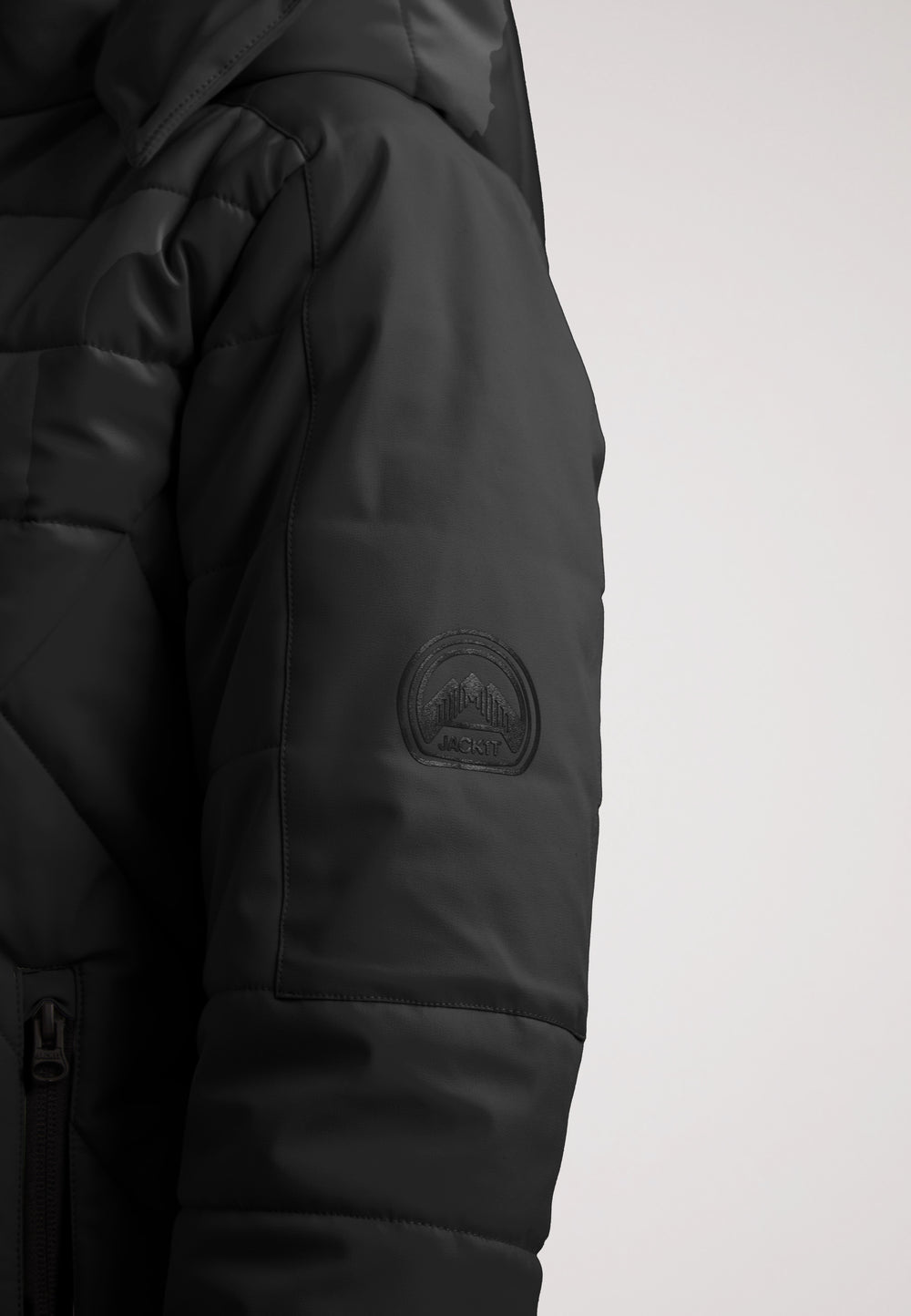 ISOTOPE Padded Jacket Black close-up showing sleeve detail and logo.