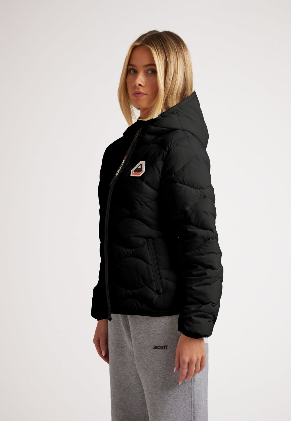 Model wearing ORB1T Quilted Puffer Jacket in black, showcasing its stylish design and cozy fit.