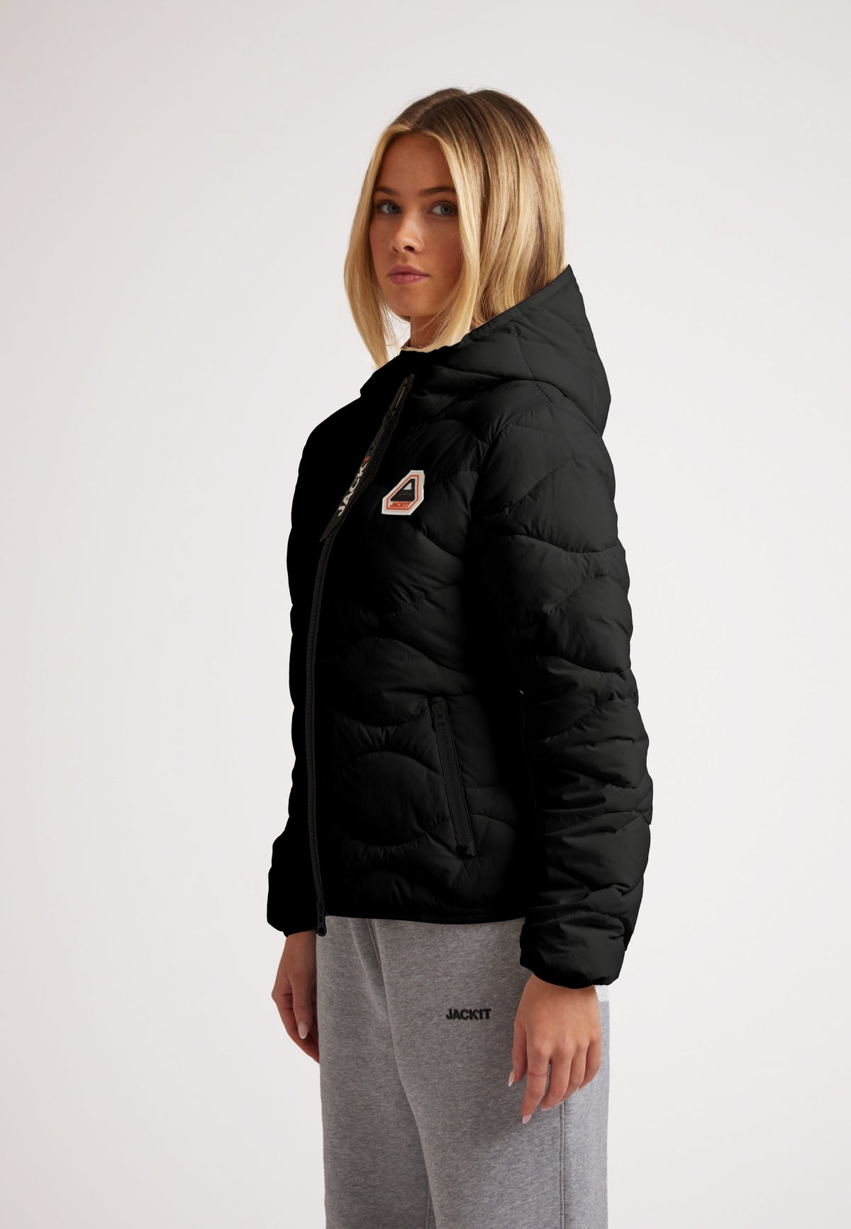 Model wearing ORB1T Quilted Puffer Jacket in black, showcasing its stylish design and cozy fit.