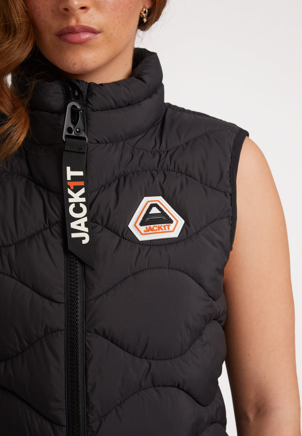 Model wearing the ORB1T Quilted Gilet Black with a badge and stylish design.