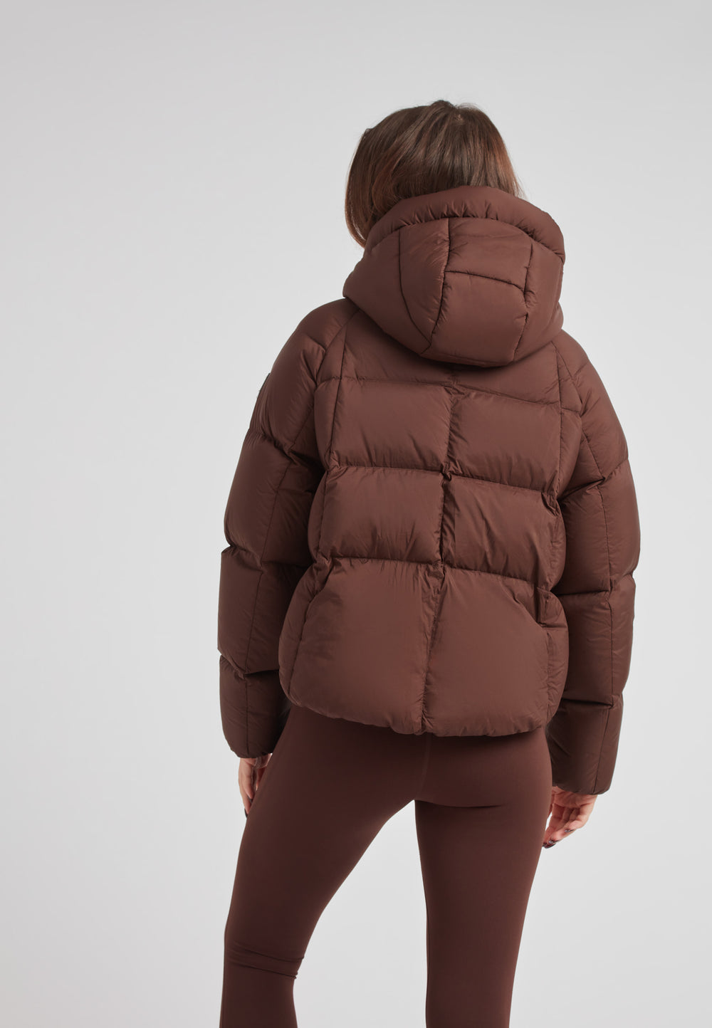 Ladies Cloud Crop Down Puffer Jacket in Mid Brown showcased from the back, featuring oversized hood and modern silhouette.